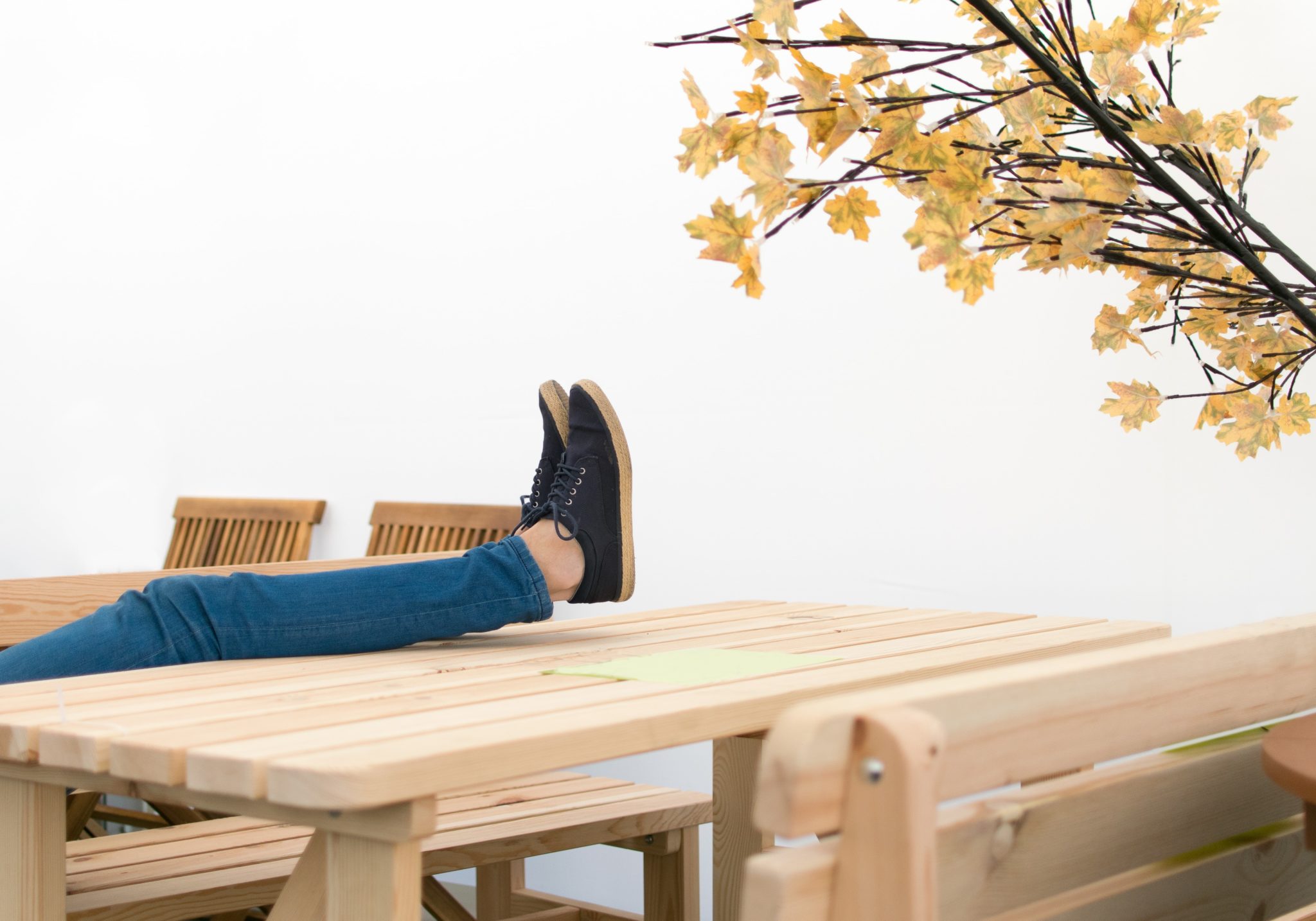 woman with feet up on table definition of complacency