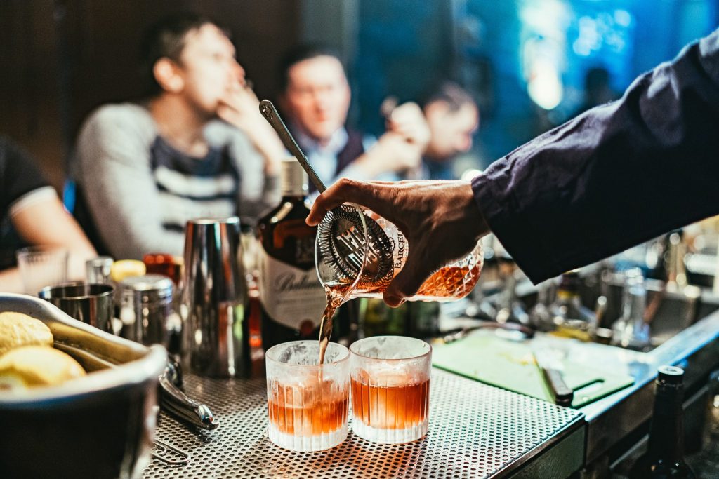 bartender pouring two cocktails