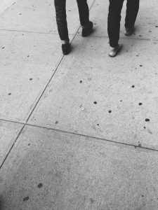 black and white shot of two people walking