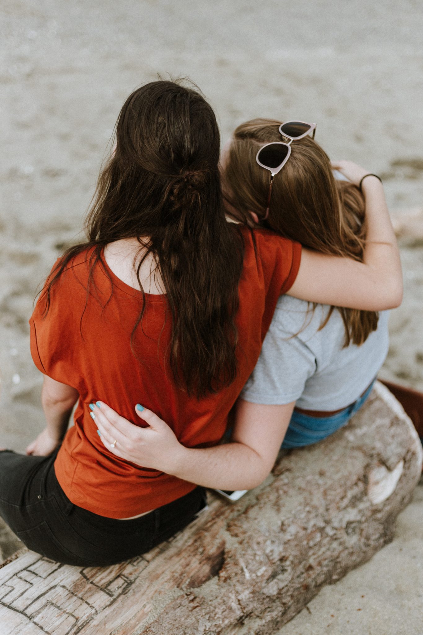 two women with arms around shoulders