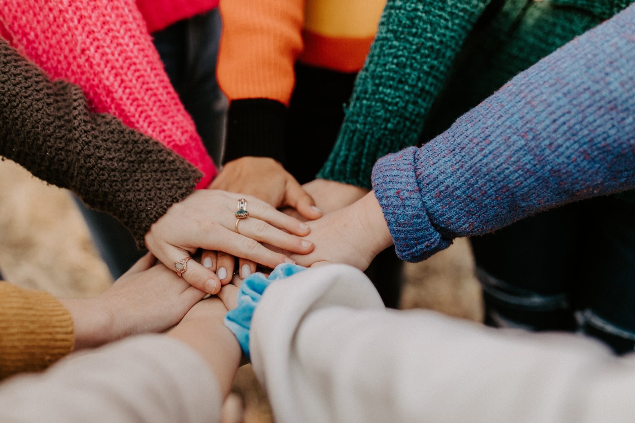 group holding hands avoiding complacency