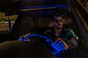 man driving a car at night