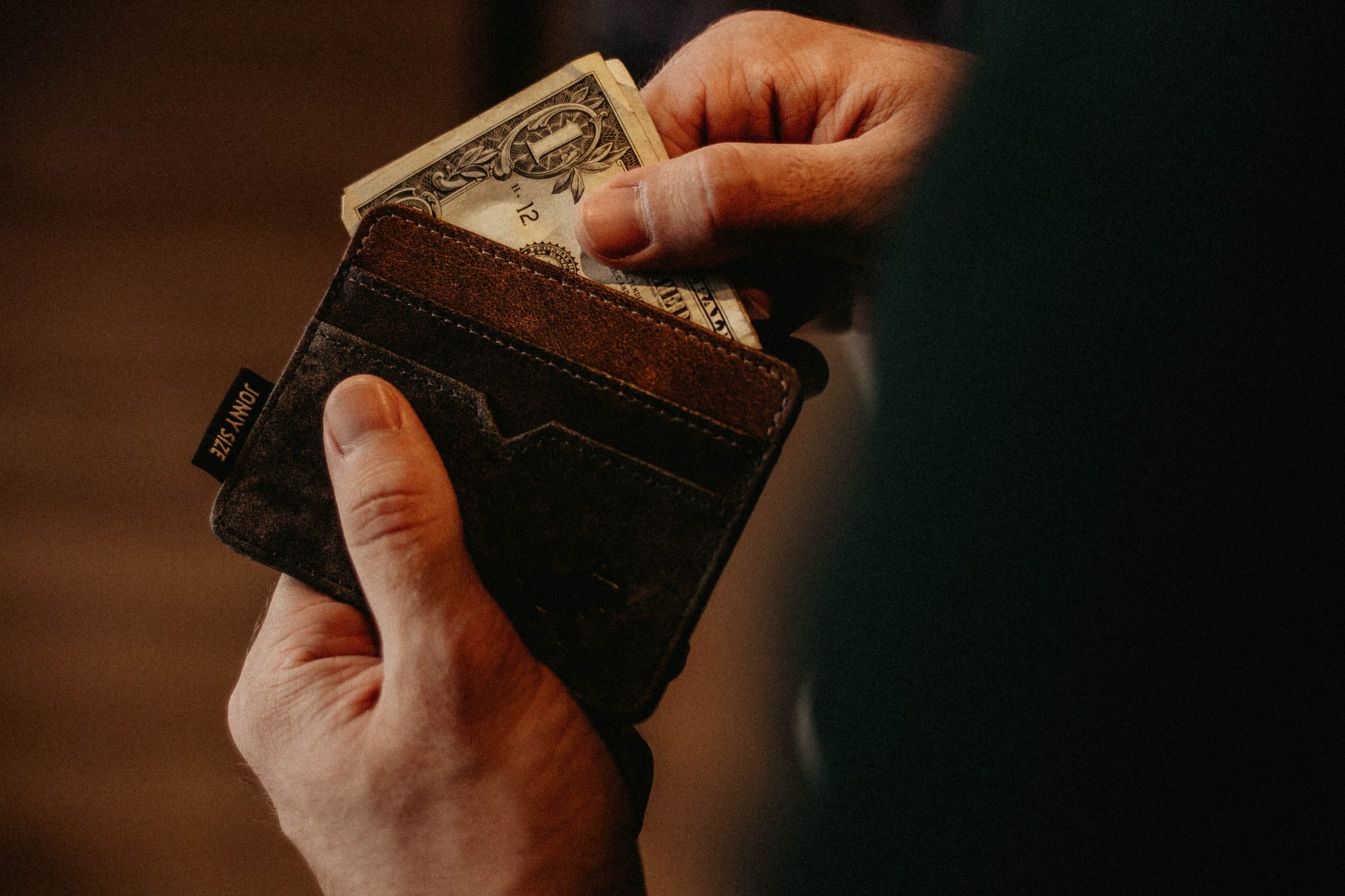 hand removing money from wallet