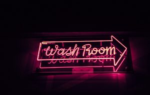 pink neon wash room sign