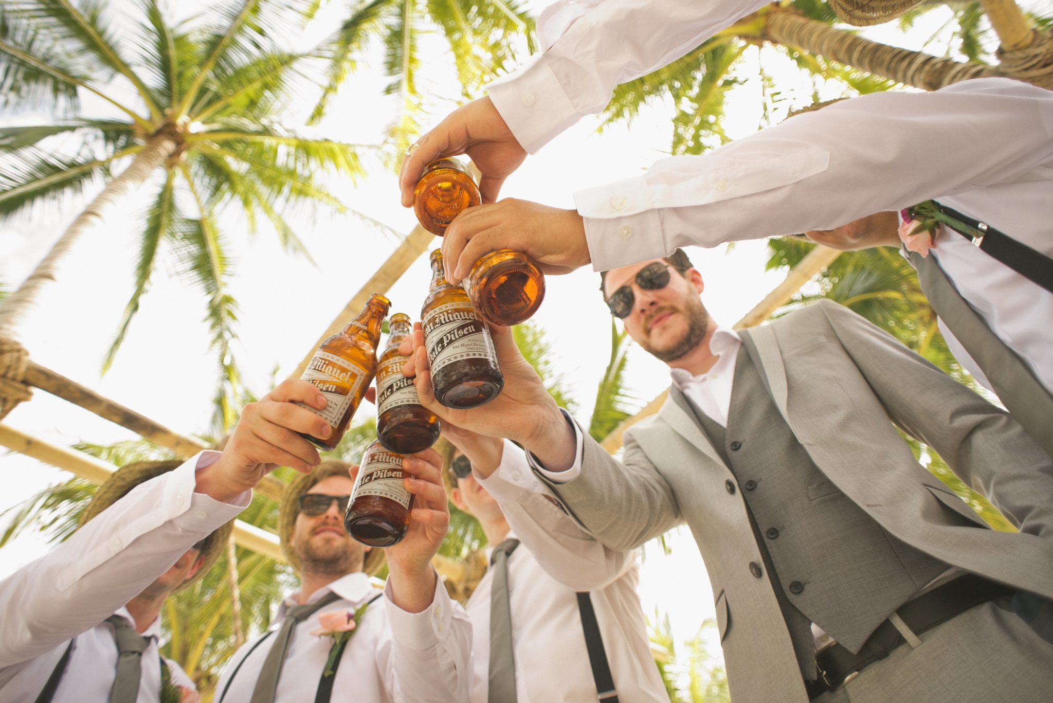 line of men raising beer glasses