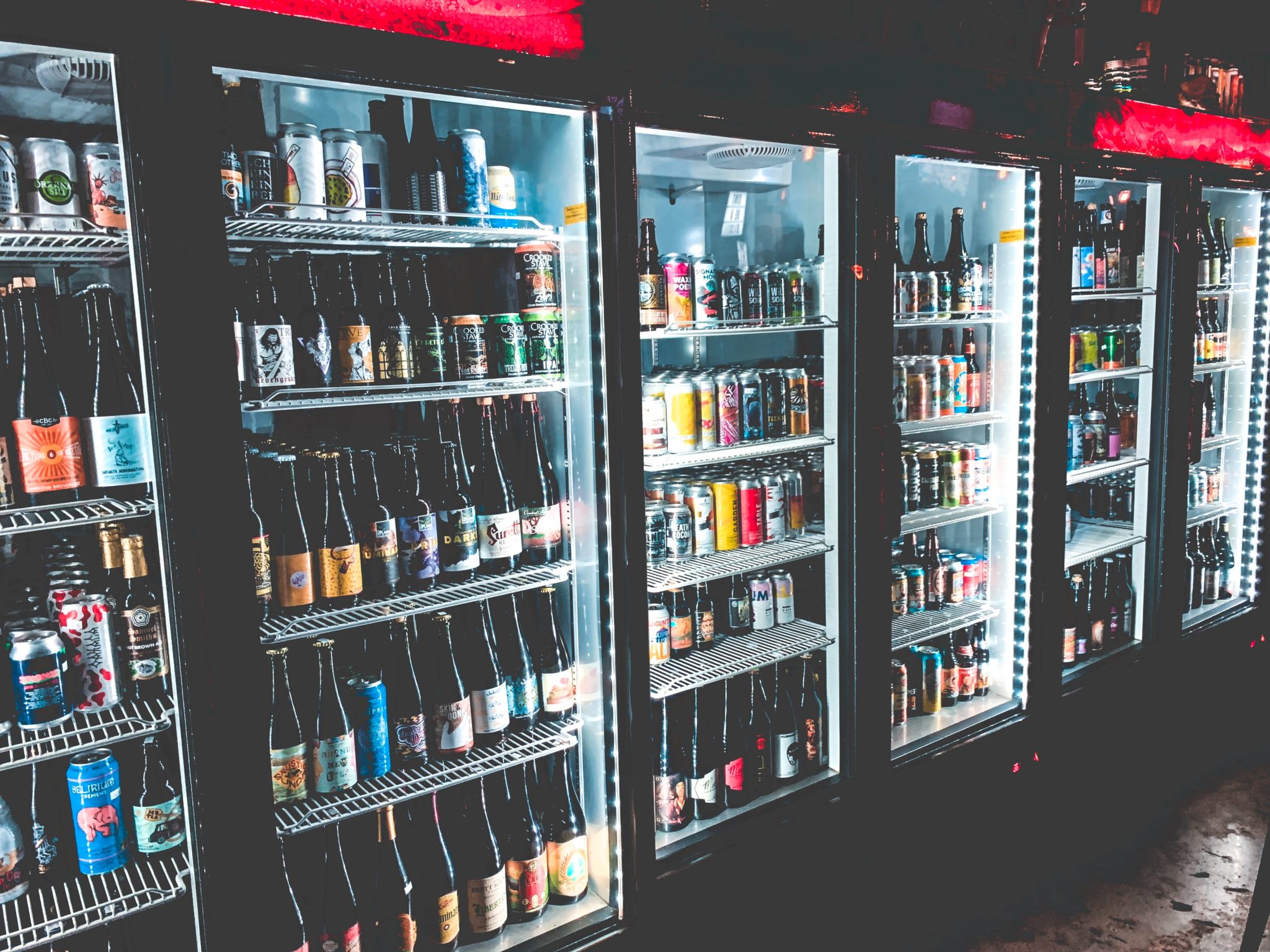 line of refrigerators containing beer