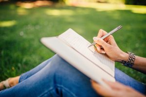 person journaling to cope with a breakup