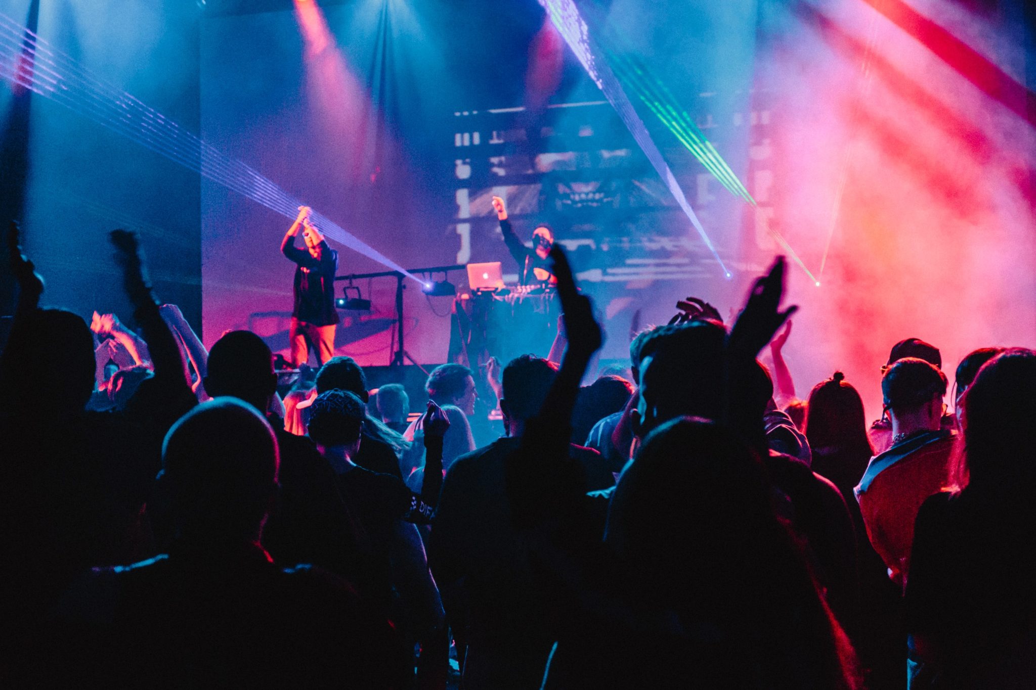 people partying under blue and red lights