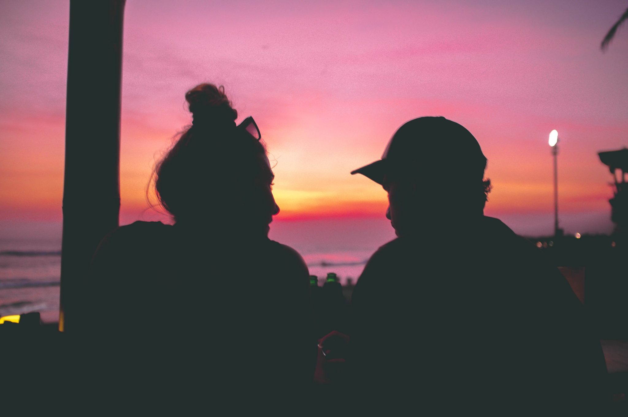 two people relaxing and talking at sunset