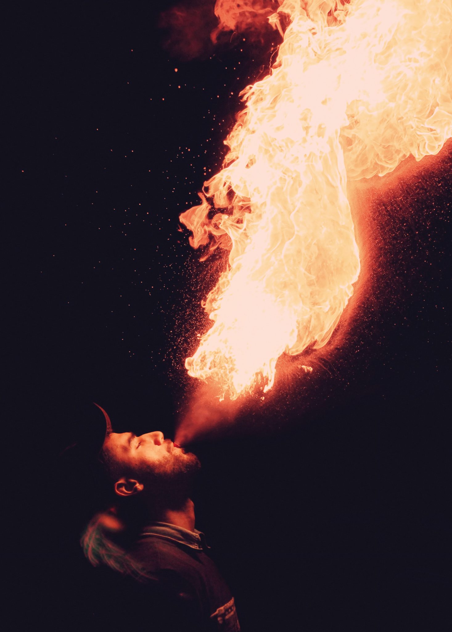 man breathing fire alcohol breath