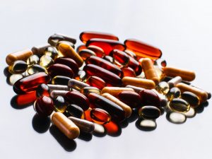 multicolored supplement pills on a white background