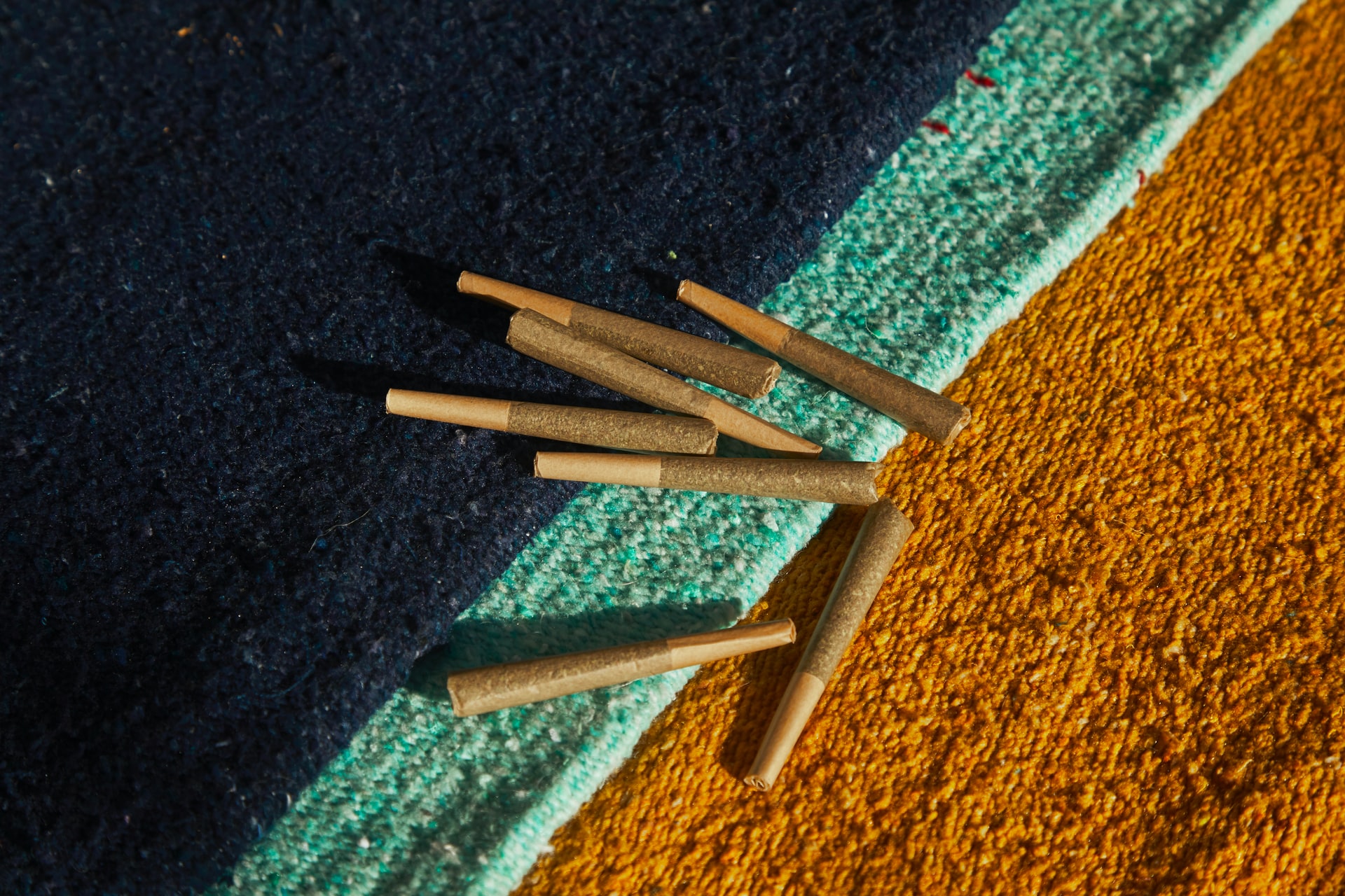 pre-rolled joints on a fabric background