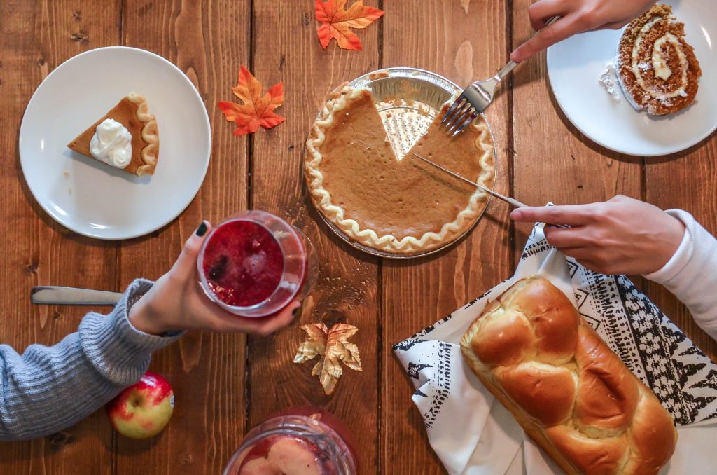 cutting pie and sharing mocktails on thanksgiving