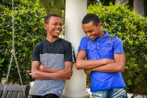 two teenage boys talking and laughing