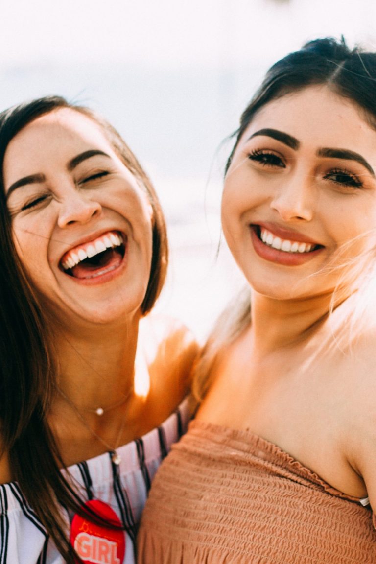 two women laughing in a close up shot