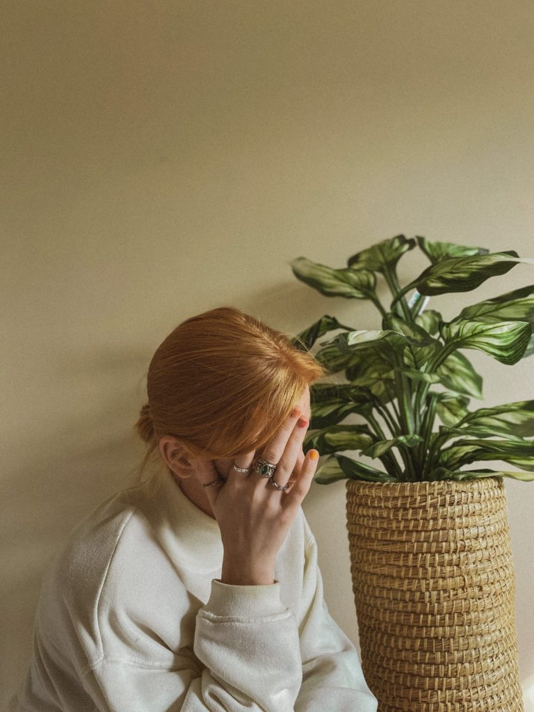 woman with hand over head worrying