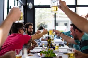 group of friends raising glasses over a meal