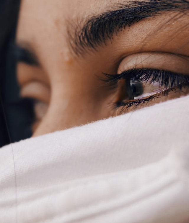 sad looking woman with partially covered face