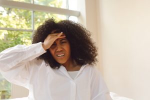 woman waking up with a hangover headache