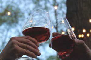 people toasting wine glasses outdoors