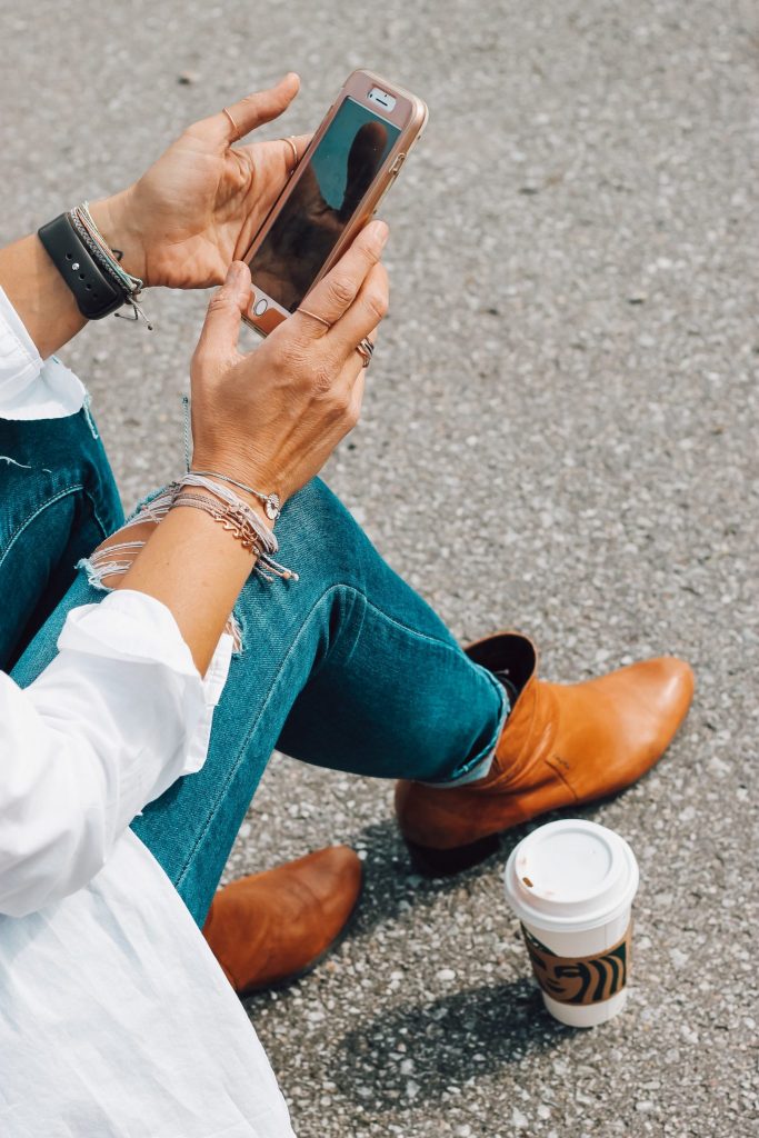 woman sitting using smartphone