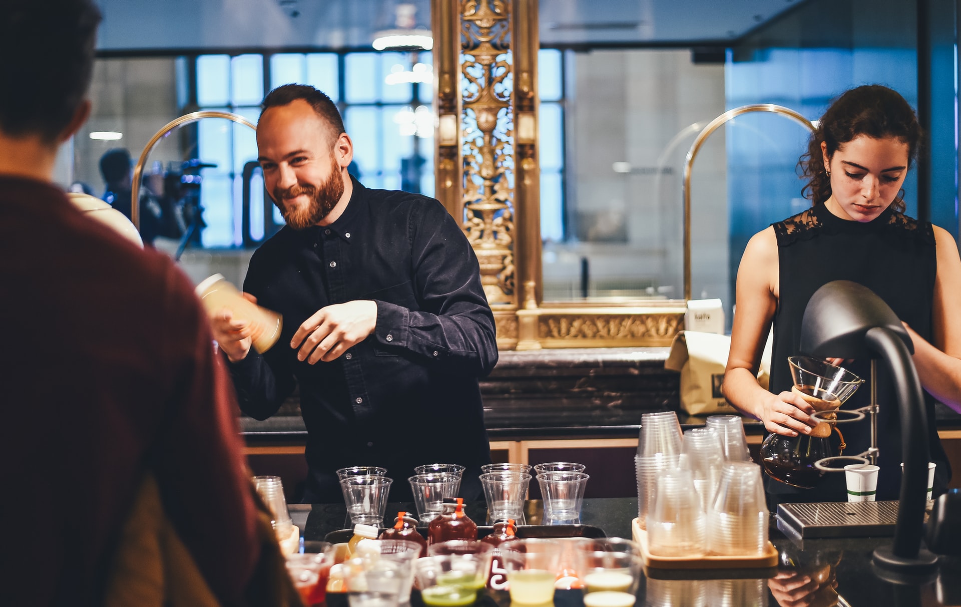 two bartenders preparing drinks