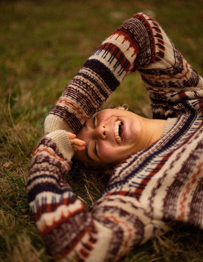 healthy person lying on grass and laughing