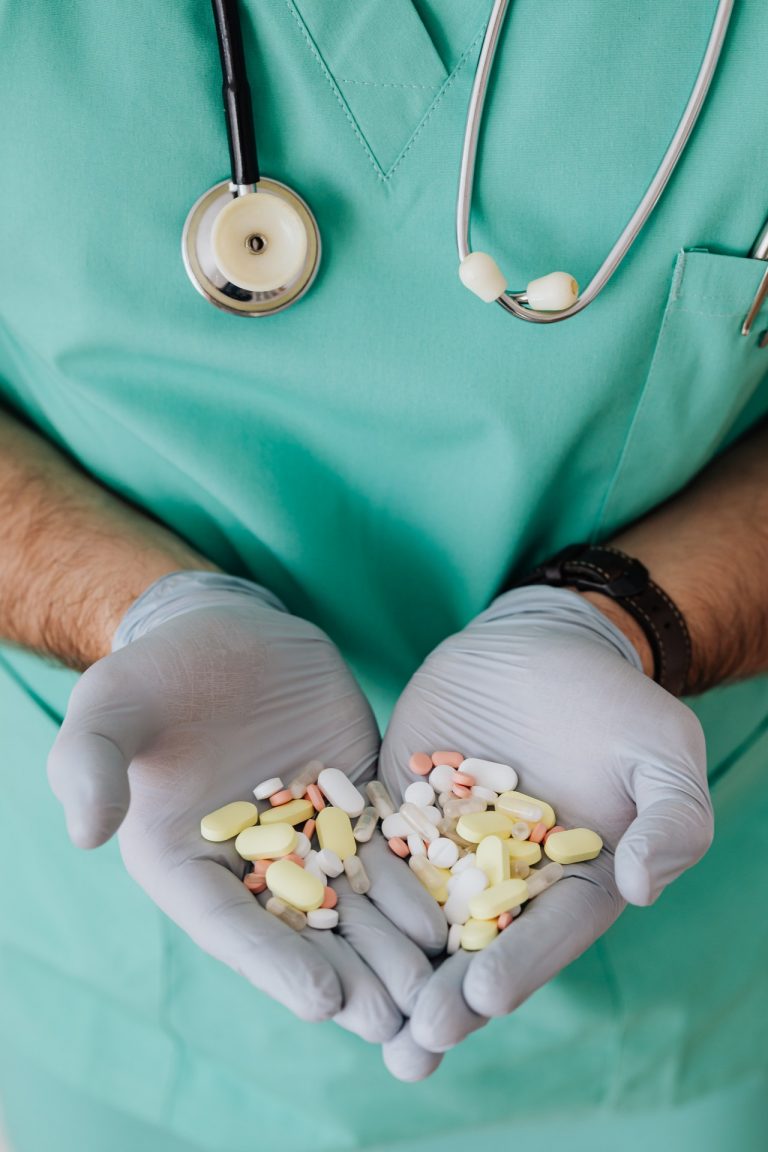 doctor holding assorted pills