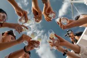 upward shot of people raising champagne glasses in a toast