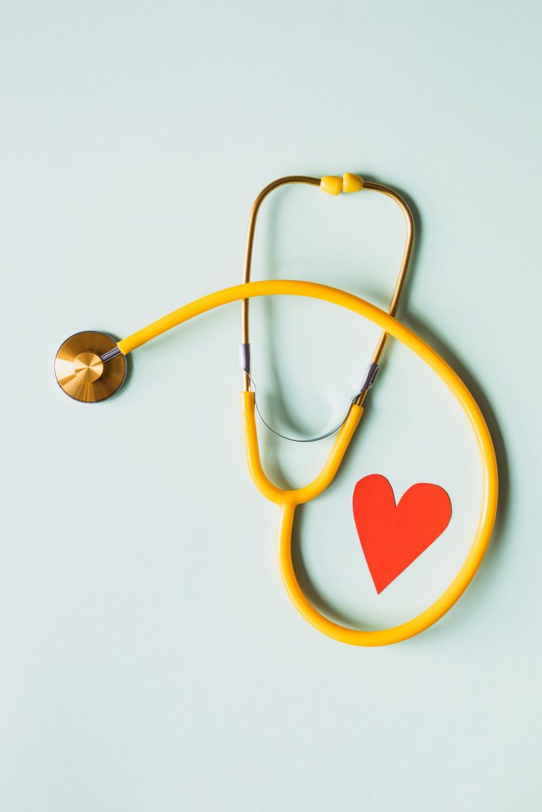medical stethoscope with red paper heart