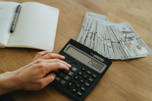 hand calculator and stack of bills