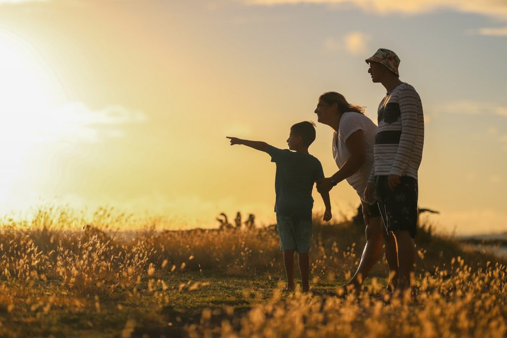 family standing in a golden field