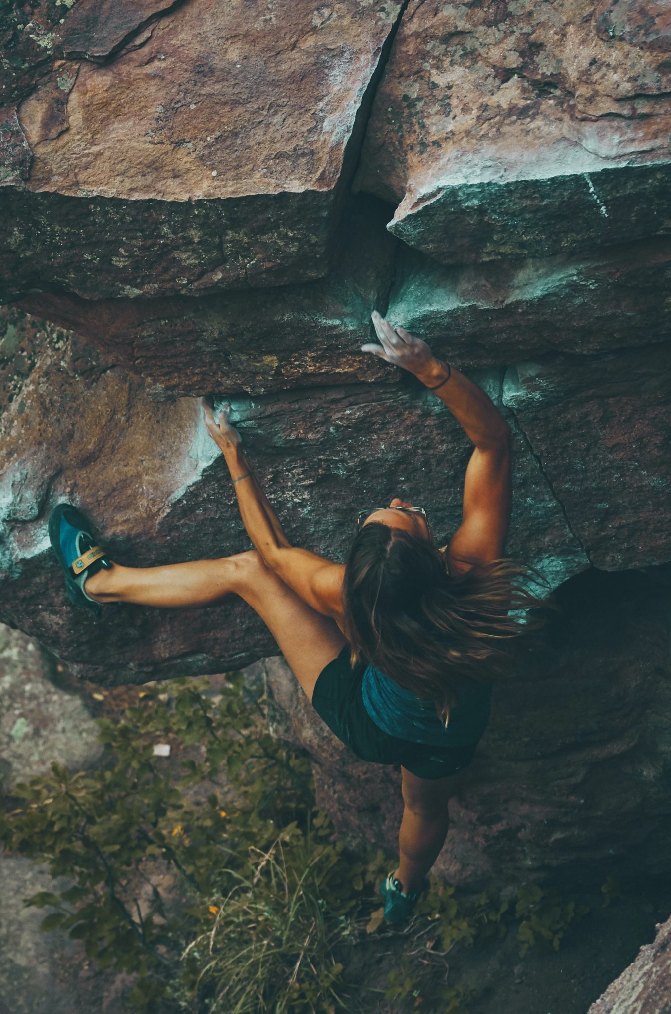 person climbing steep rock face
