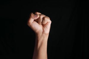 clenched fist on black background