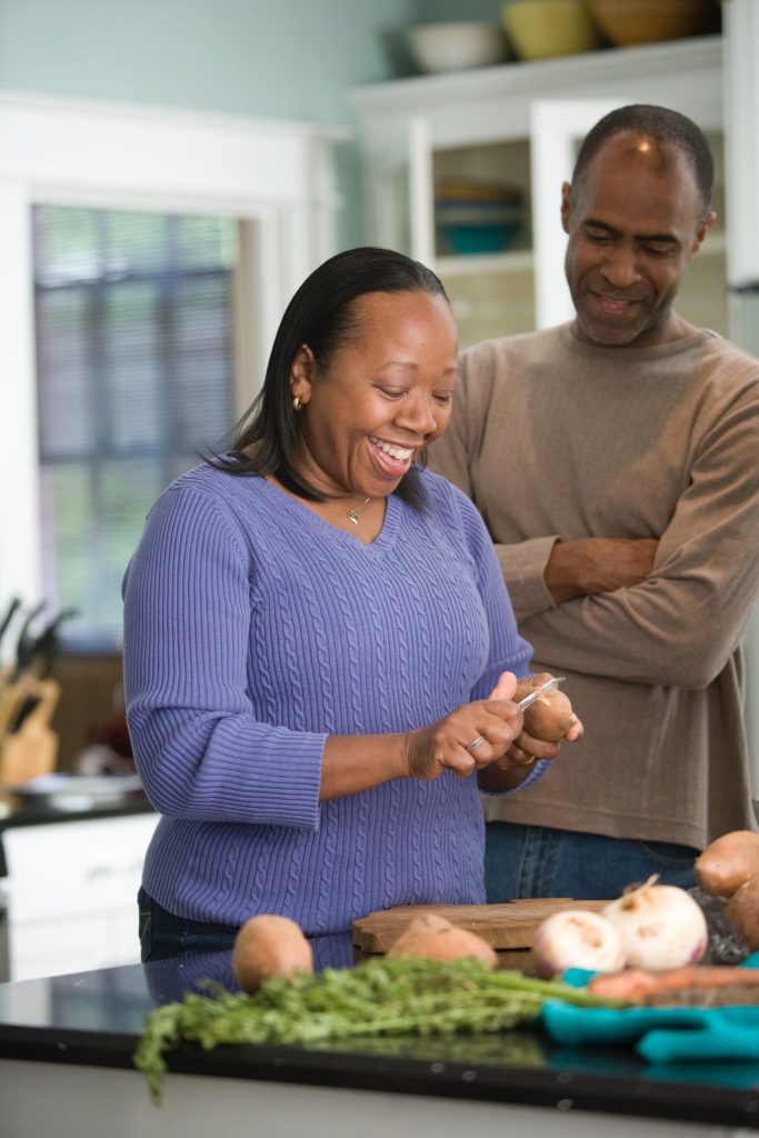 middle aged couple cooking in the kitchen