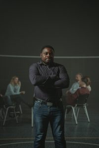 man standing in front of group meeting