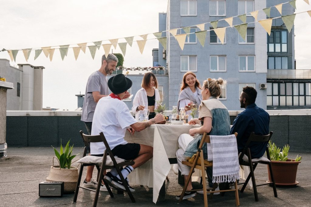 group of friends gathering at outdoor roof table