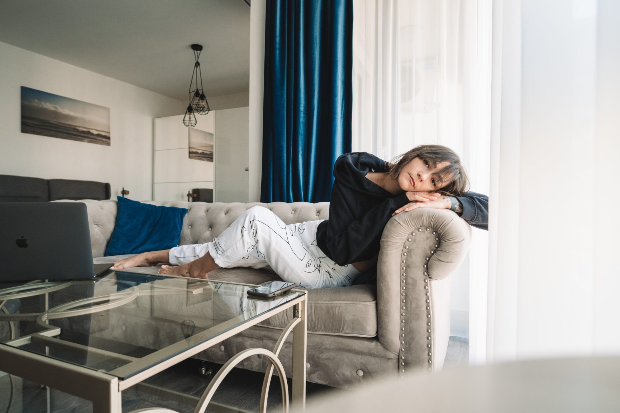 woman lying on couch looking bored