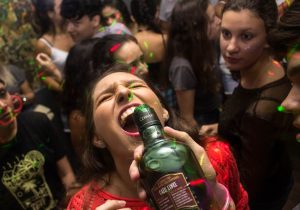 woman in red shirt drinking