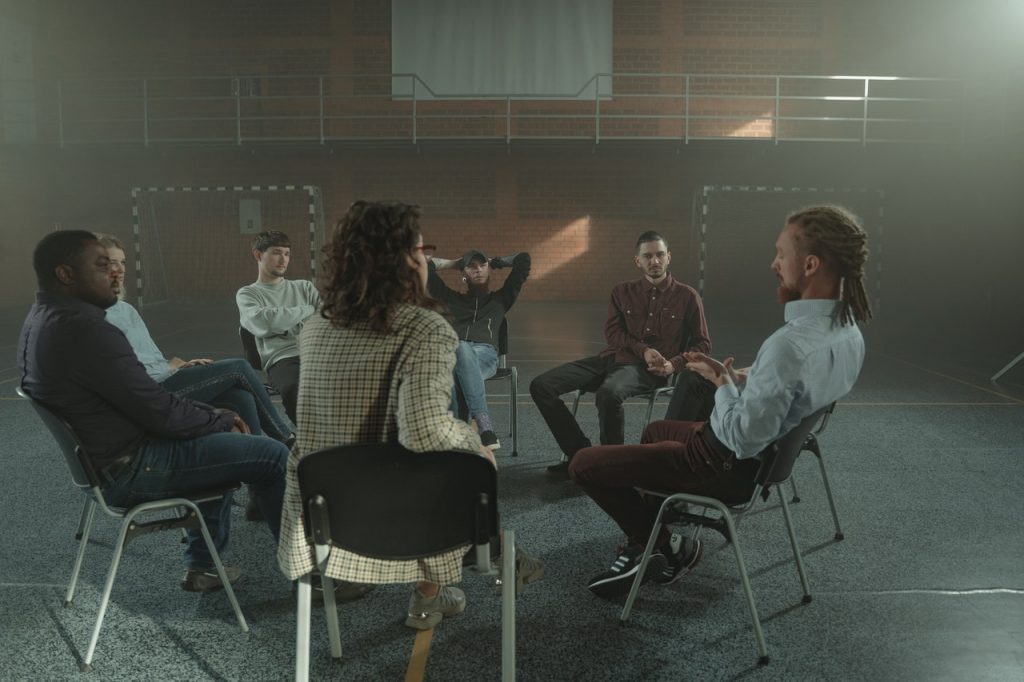 people sitting on chairs at support group meeting