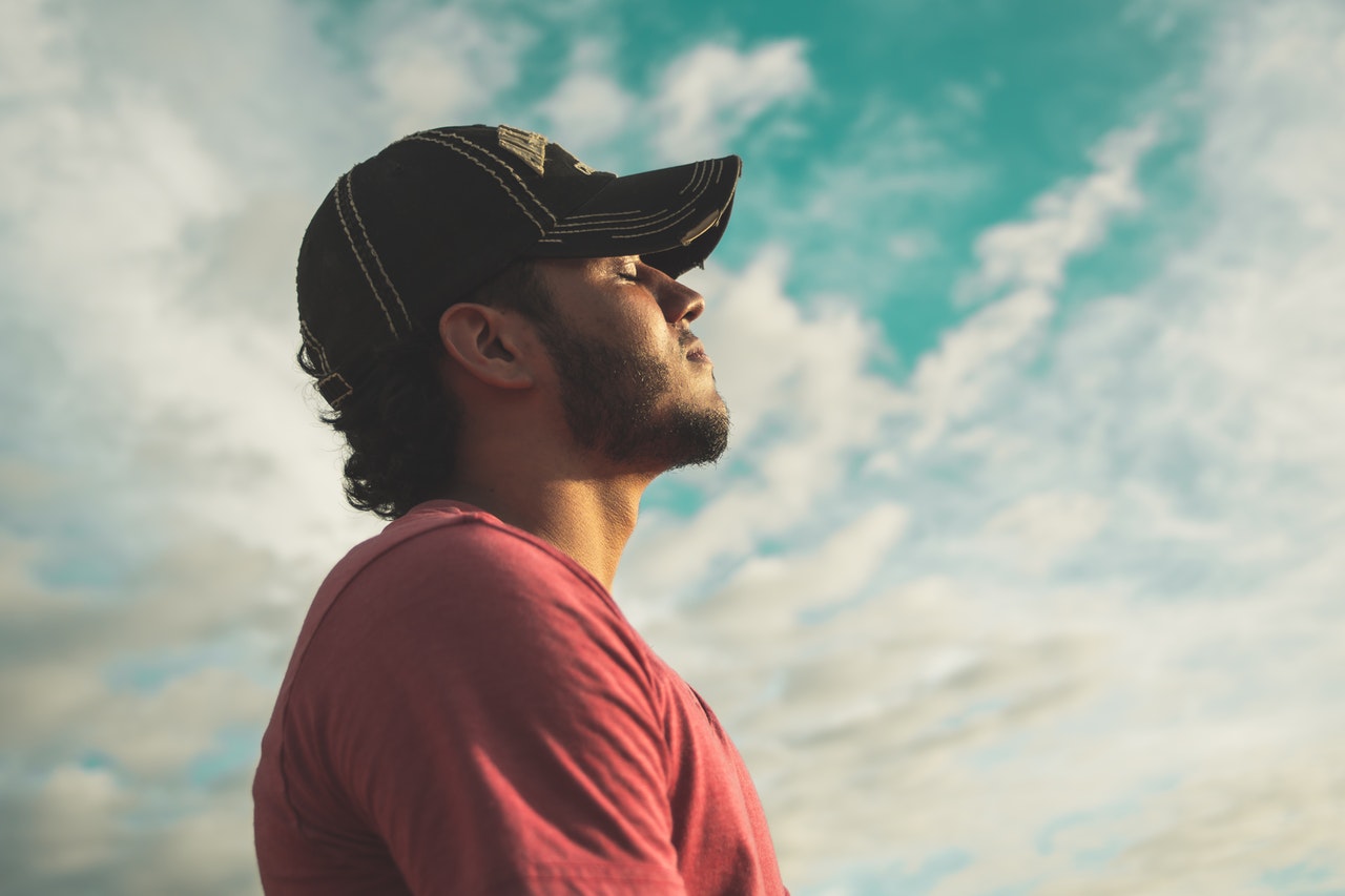 man in black baseball cap practicing mindfulness