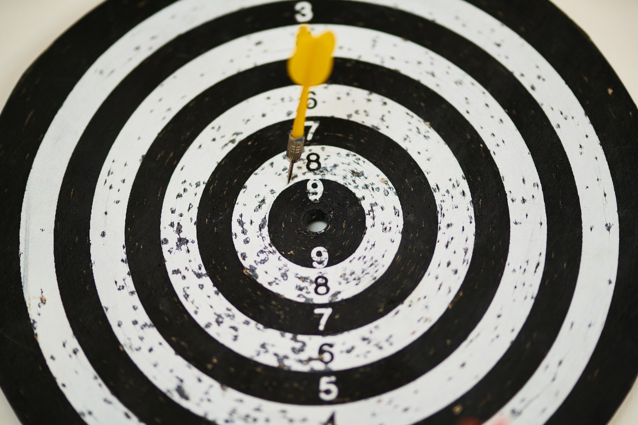 black and white dartboard with single dart