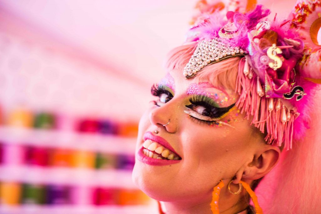 extroverted woman in bright pink smiling