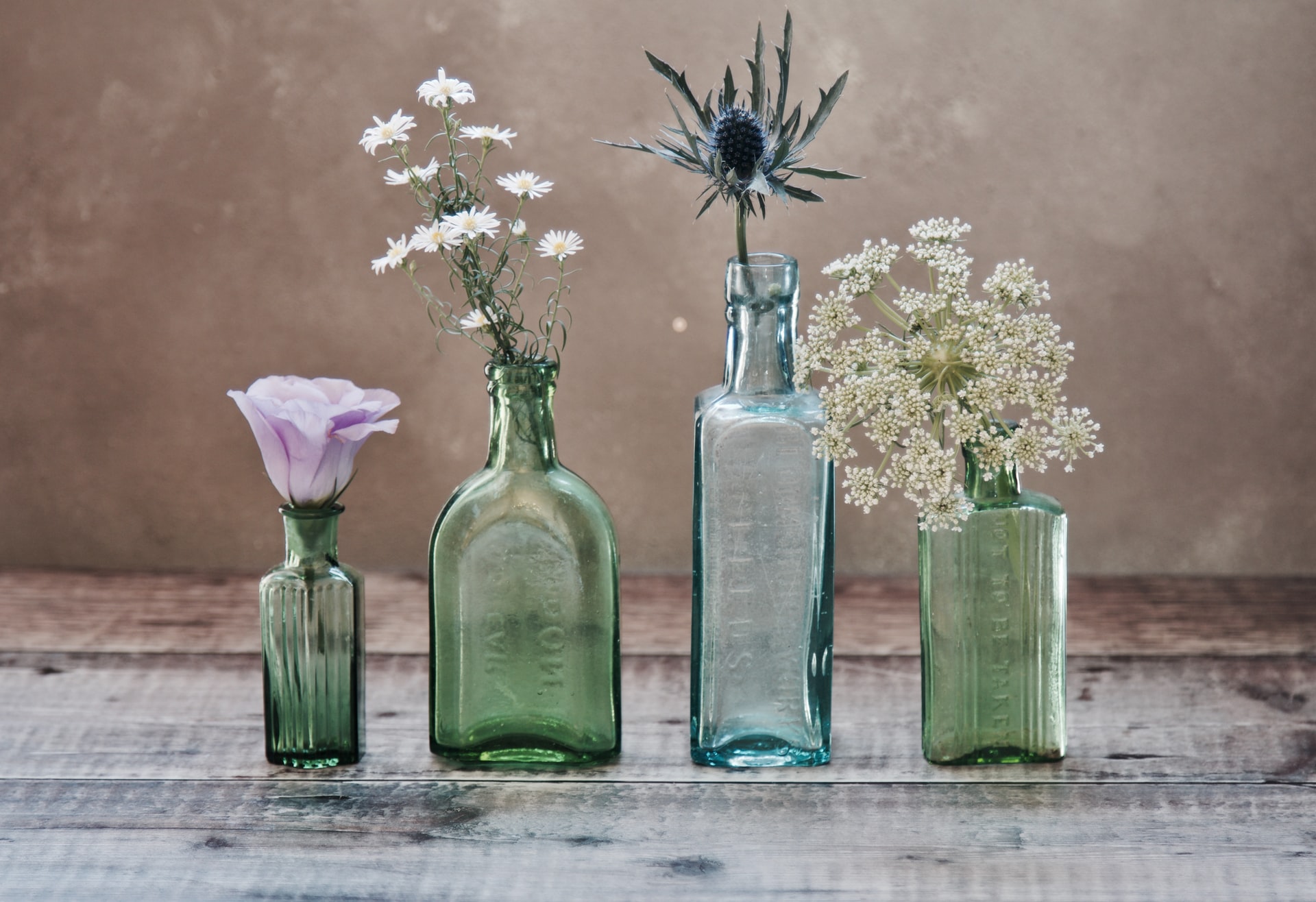 4 glass bottles reused as vases