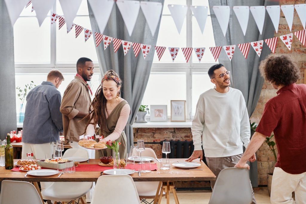 friends gathered around a potluck table at a party