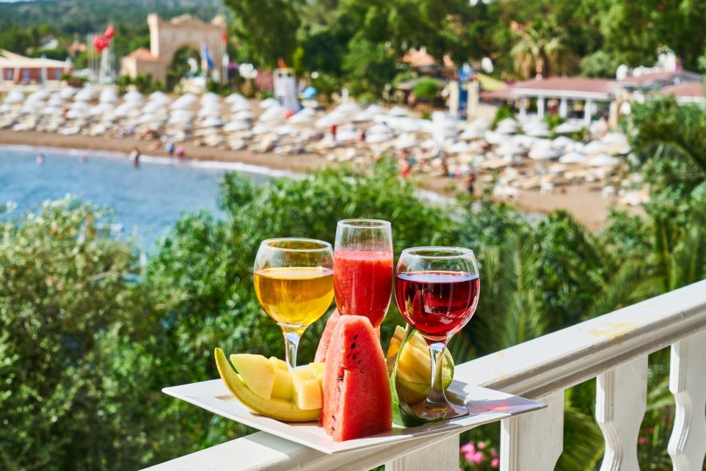 tray with cocktails overlooking resort waterfront