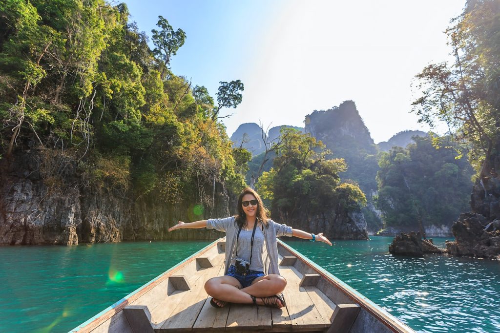 woman sitting in boat on tropical river