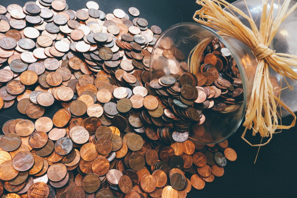 jar full of coins poured on table