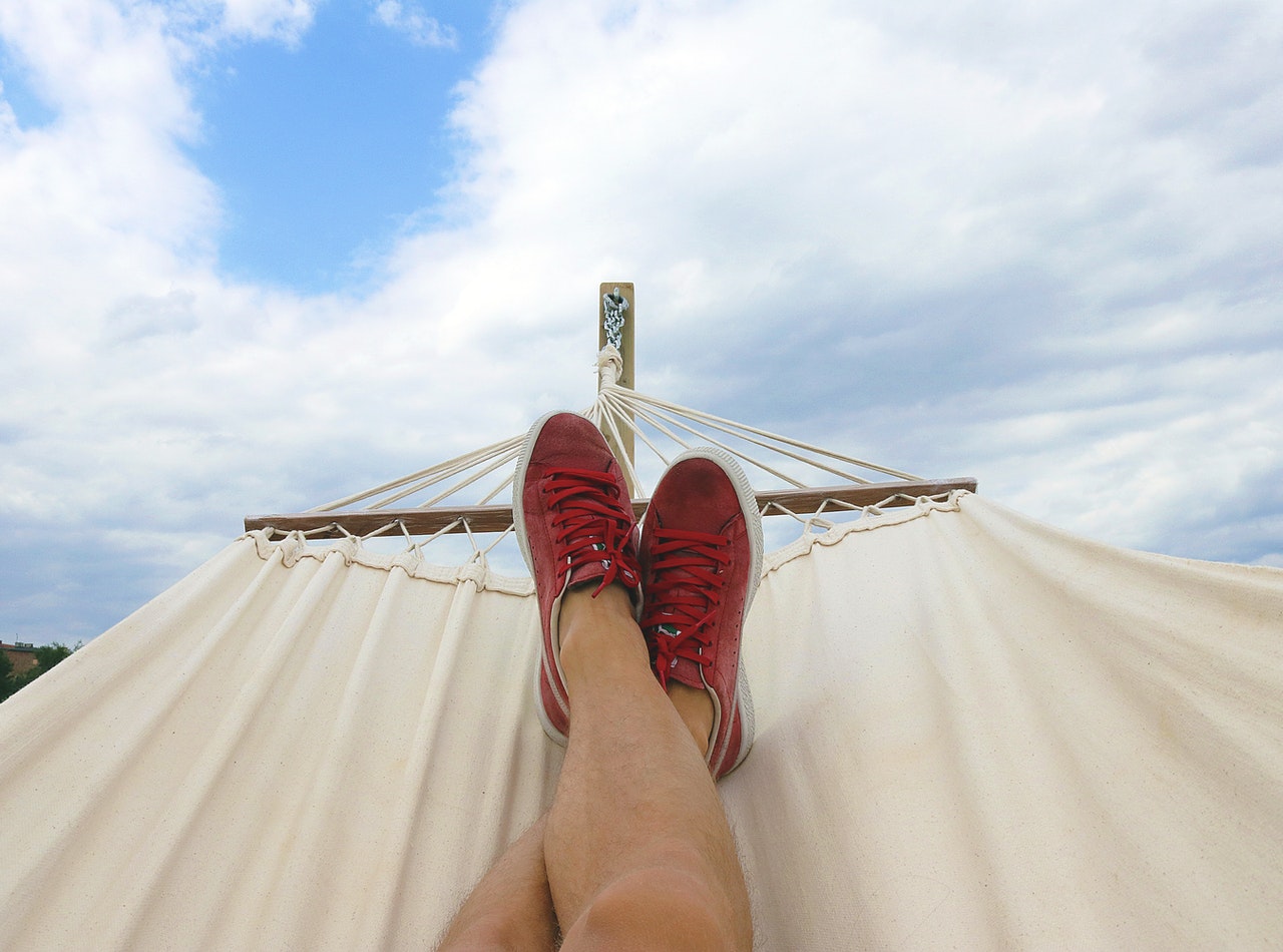 two feet in red sneakers on hammock