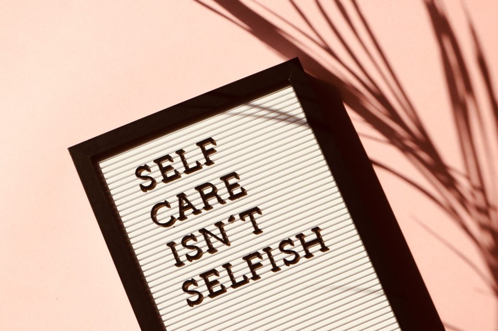 sign reading "self care isn't selfish"